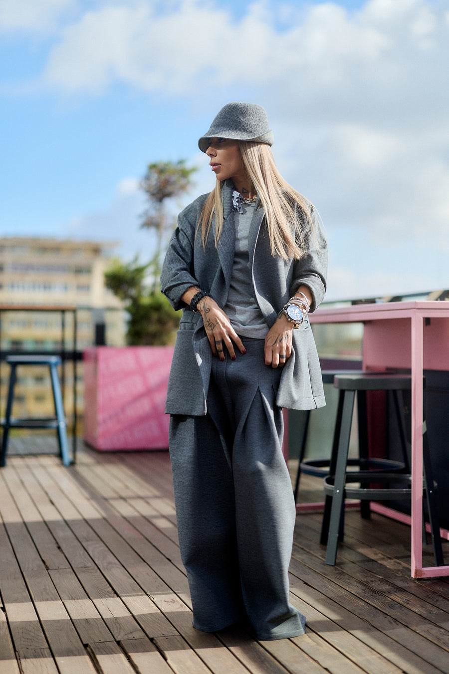 Gray Oversized Blazer worn by a fashionable model outdoors, showcasing a minimalistic yet sculptural silhouette.
