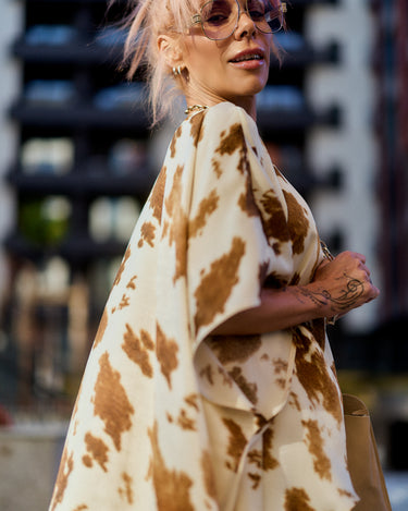 Beige Printed Asymmetric Tunic worn by a model with pink hair, showing an artistic camel abstract print and modern silhouette.