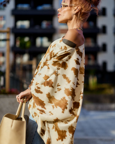 Beige Printed Asymmetric Tunic worn off one shoulder, featuring camel-toned abstract print and a stylish drape.