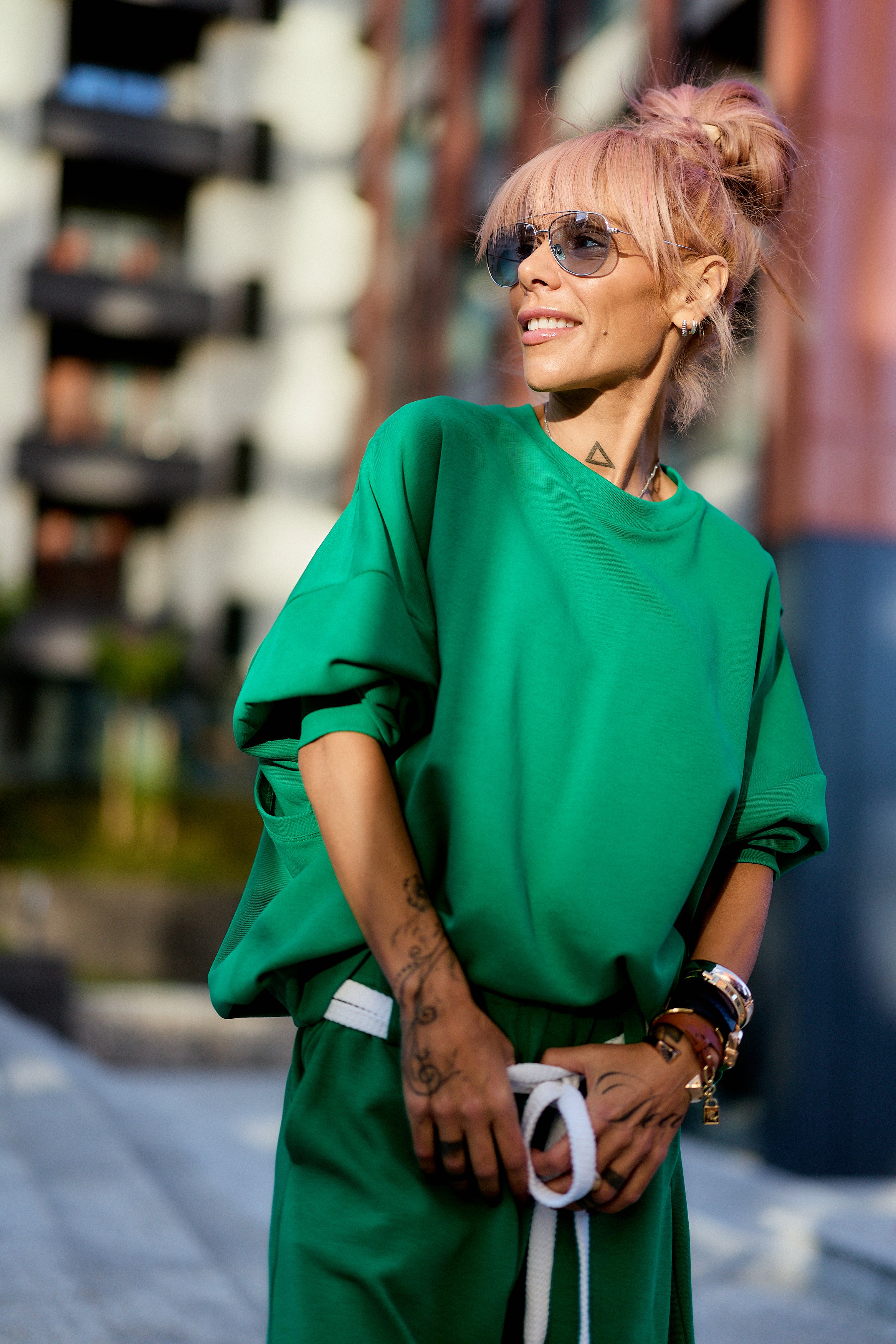 Green Oversized Sweat Set with Open Back showcased in urban setting on a model with sunglasses and stylish accessories.