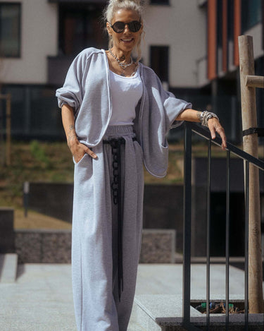 Woman wearing a Grey Relaxed Lounge Set, featuring a cropped top and wide-leg pants, stylishly posed outdoors.