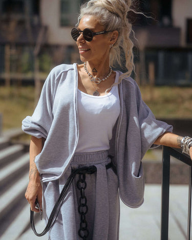 Woman wearing a Grey Relaxed Lounge Set, styled with sunglasses and accessories, in an outdoor setting.