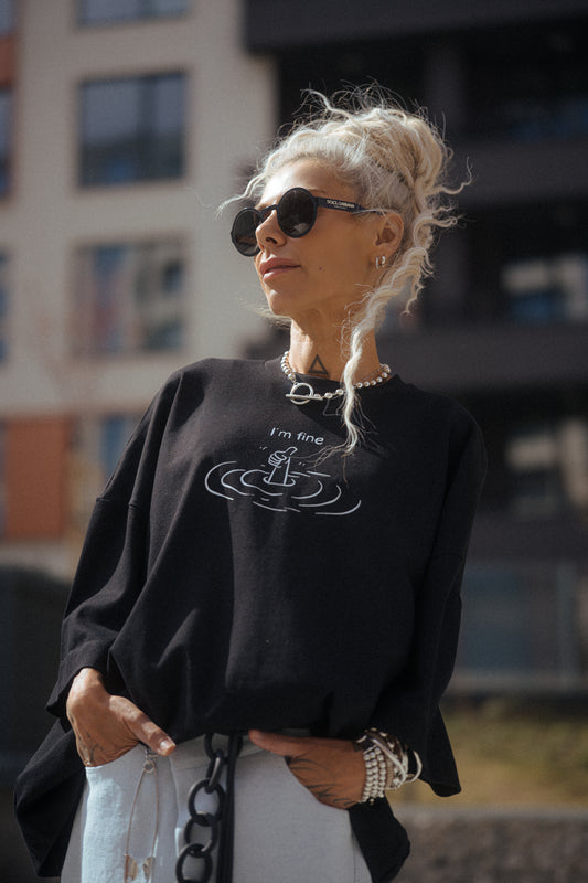 Black Oversized “I’m Fine” Graphic T-Shirt worn by a model outdoors with sunglasses.