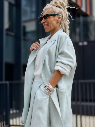 Light Mint Pinstripe Oversized Blazer worn by a stylish model in an urban setting, showcasing relaxed fit and soft mint shade.