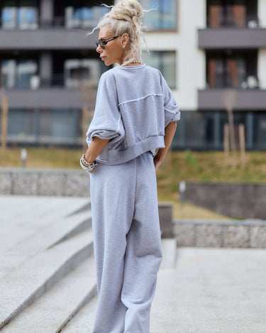 Grey Relaxed Lounge Set featuring a cropped top and wide-legged pants in a stylish outdoor setting.