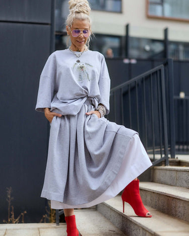 Grey Oversized Graphic T-Shirt styled with a long skirt and red heels, showcasing a trendy urban look.