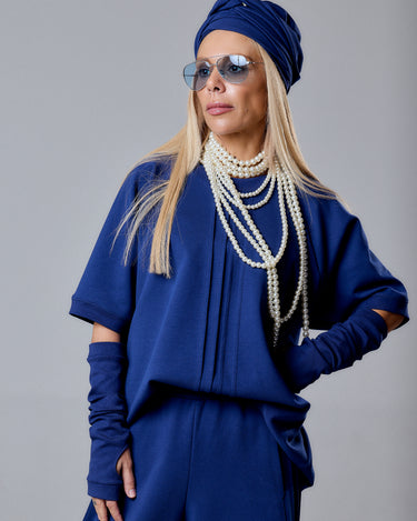 Woman wearing Navy Blue 3-Piece Set with sunglasses and pearl necklace, showcasing modern and relaxed fashion.