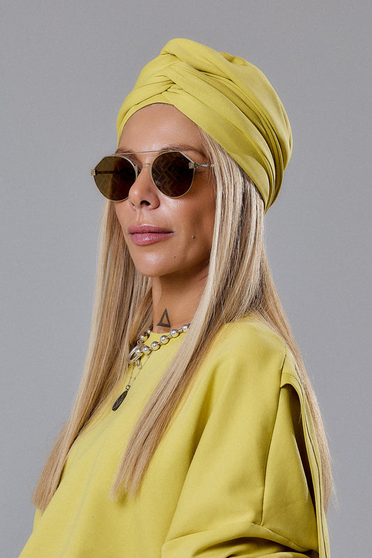 Model wearing a Dark Yellow Turban Hat and stylish sunglasses, showcasing modern urban fashion.