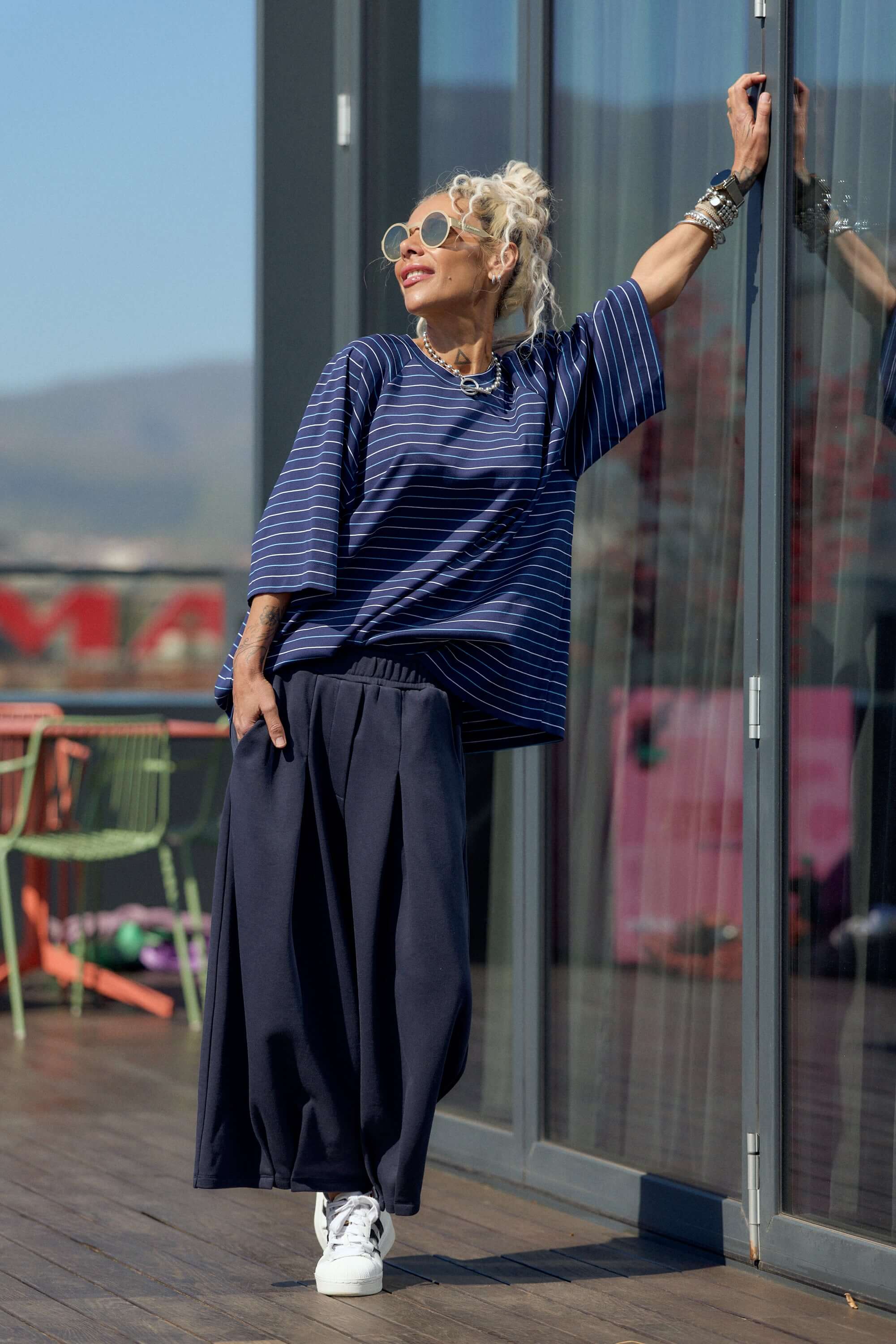 Model wearing Oversized Striped Set featuring striped T-shirt and wide-leg trousers, showcasing urban style and comfort.