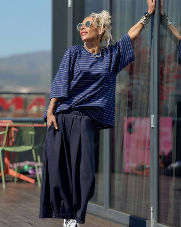 Model wearing Oversized Striped Set featuring striped T-shirt and wide-leg trousers, showcasing urban style and comfort.