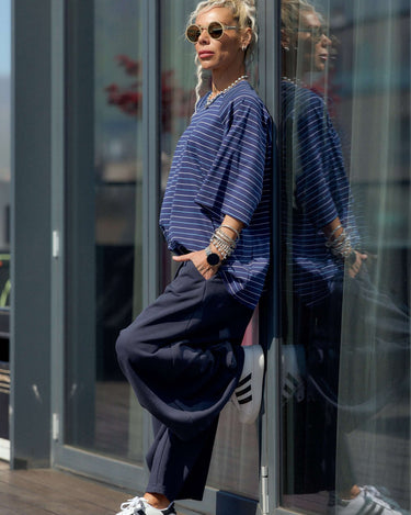 Oversized Striped Set featuring a relaxed striped T-shirt and fluid wide-leg trousers in a chic urban setting.