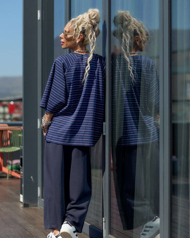 Oversized Striped Set featuring a relaxed striped T-shirt and fluid wide-leg trousers, creating an urban aesthetic.