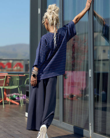 Oversized Striped Set featuring a relaxed T-shirt and wide-leg trousers against a modern urban backdrop.
