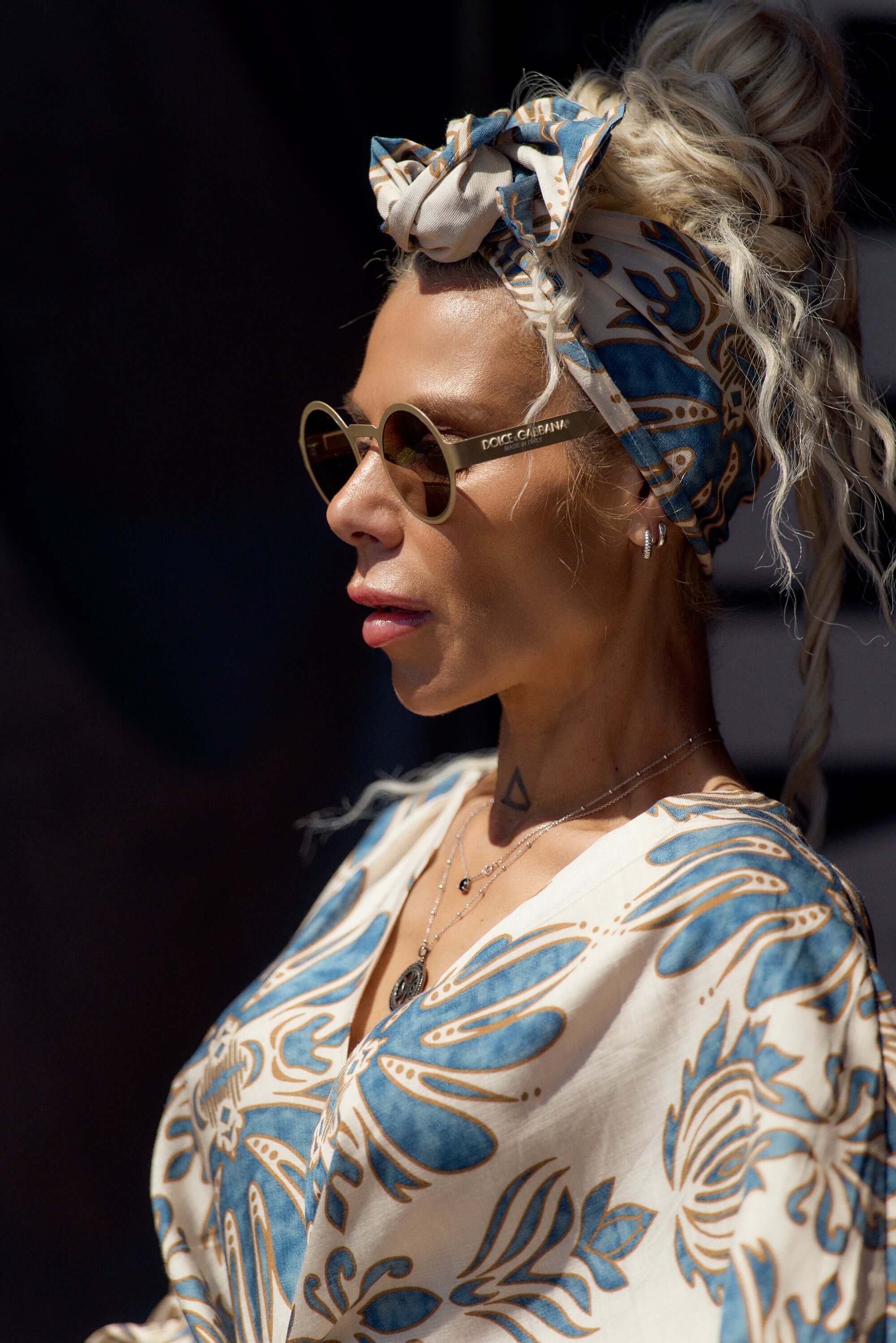 Woman wearing a Printed Bohemian Headband with oversized knot detail and stylish sunglasses.