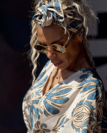 Woman wearing a Bohemian Print Two-Piece Co-ord Set with oversized sleeves and a stylish headband.