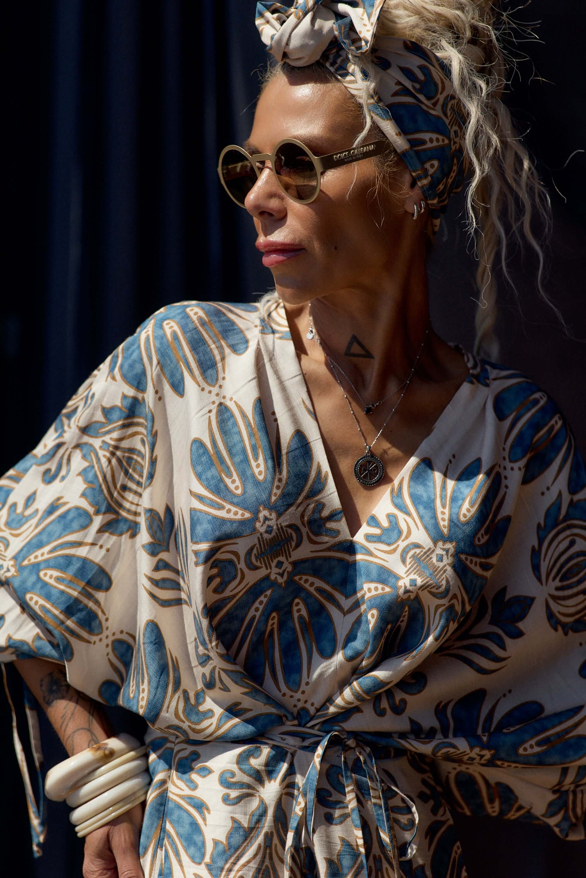Stylish woman wearing a Printed Bohemian Headband with a floral patterned outfit and sunglasses.