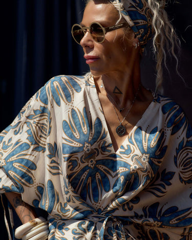 Stylish woman wearing a Printed Bohemian Headband with a floral patterned outfit and sunglasses.