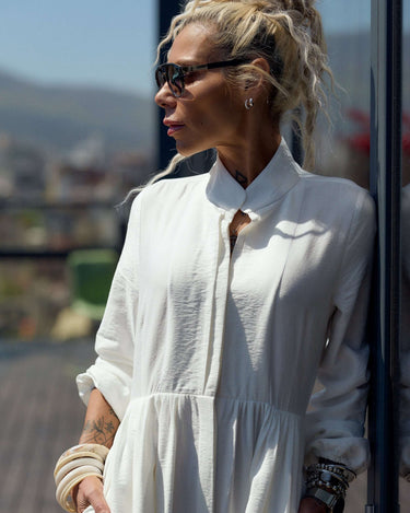 Flowing White Maxi Dress worn by a stylish woman with sunglasses, showcasing a relaxed silhouette and elegant design.