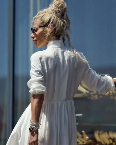 Model wearing a Flowing White Maxi Dress, showcasing its elegant silhouette and relaxed vibe.