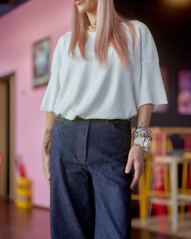 Wide-Leg Raw Denim Jeans worn by a woman with pink hair and sunglasses, showcasing a modern street style.