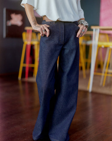 Wide-Leg Raw Denim Jeans featuring a high-rise waist and minimal distressing, showcasing a stylish silhouette.