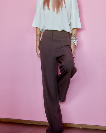 Wide-Leg Tailored Pants in Dark Brown worn with a white top, showcasing a comfortable and stylish silhouette.