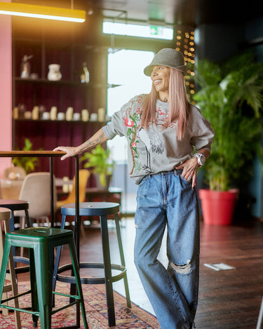 Printed Oversized Blouse Top styled in a relaxed setting with casual jeans and accessories.