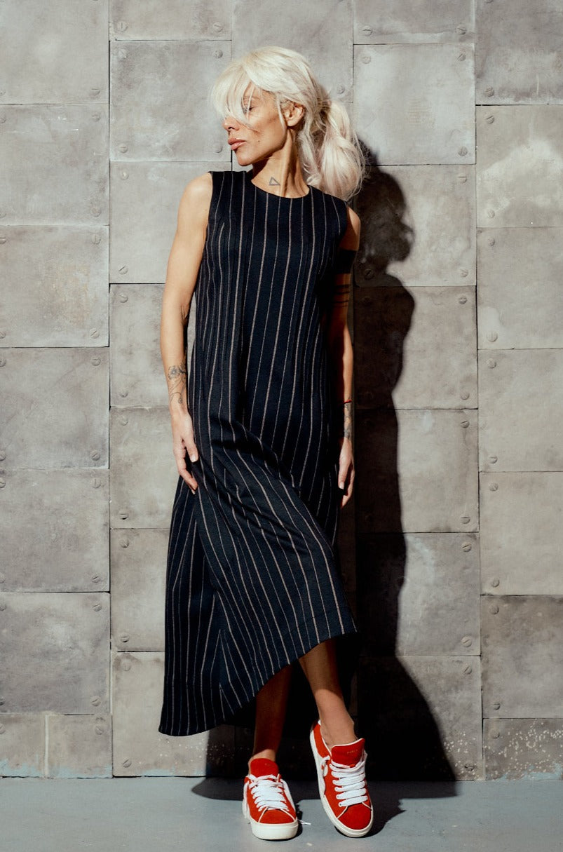 Elevate your wardrobe with this sophisticated striped midi dress. Designed for style and comfort, it combines classic elegance with a modern twist. Perfect for both daytime engagements and evening outings, this dress promises to keep you looking sharp and feeling comfortable.