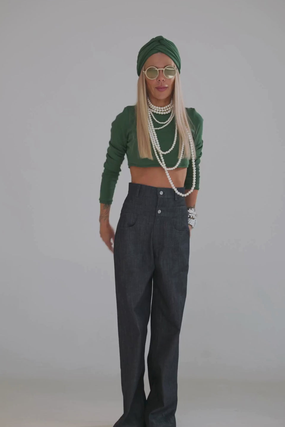 Model showcasing a Green Cropped Top paired with high-waisted denim pants and accessories.