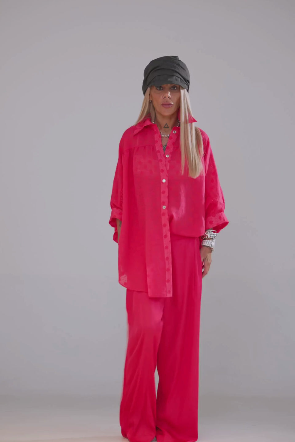 Model wearing Coral Wide-Leg Pants paired with a vibrant oversized shirt and stylish accessories.