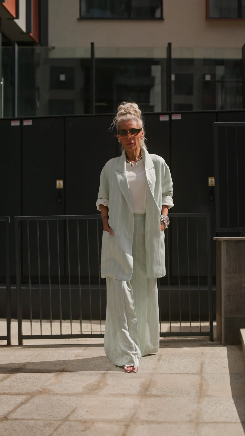 Light Mint Pinstripe Wide-Leg Trousers worn with a matching blazer, showcasing a stylish and sophisticated outfit.