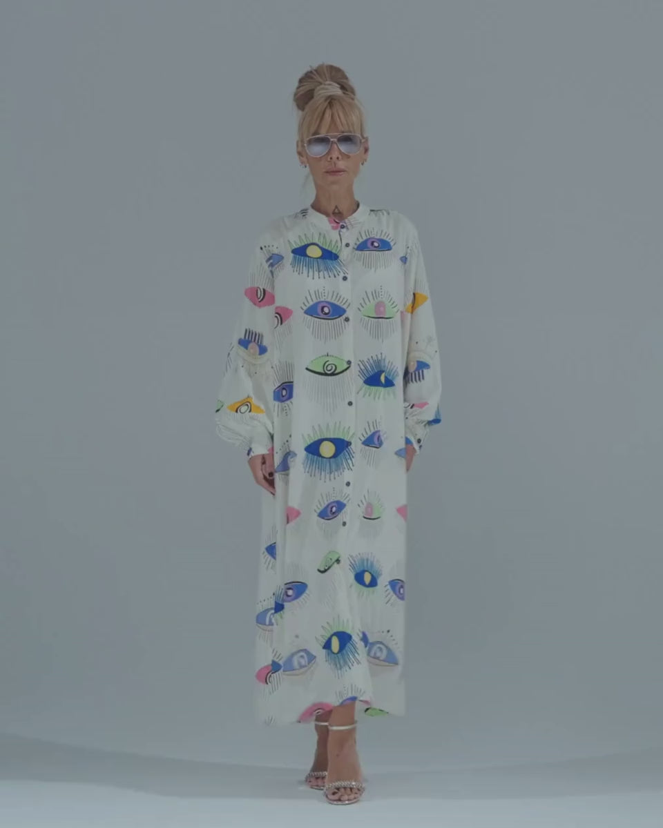 Bold Eye Print Shirt Dress in vibrant colors, featuring ¾ sleeves and front button closure for stylish city wear.