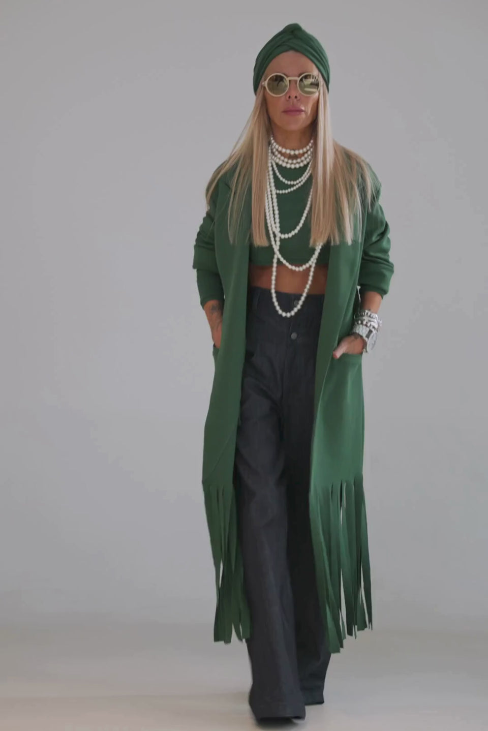 Model showcasing a Green Long Coat with Fringe Detail, paired with a stylish outfit and accessories.