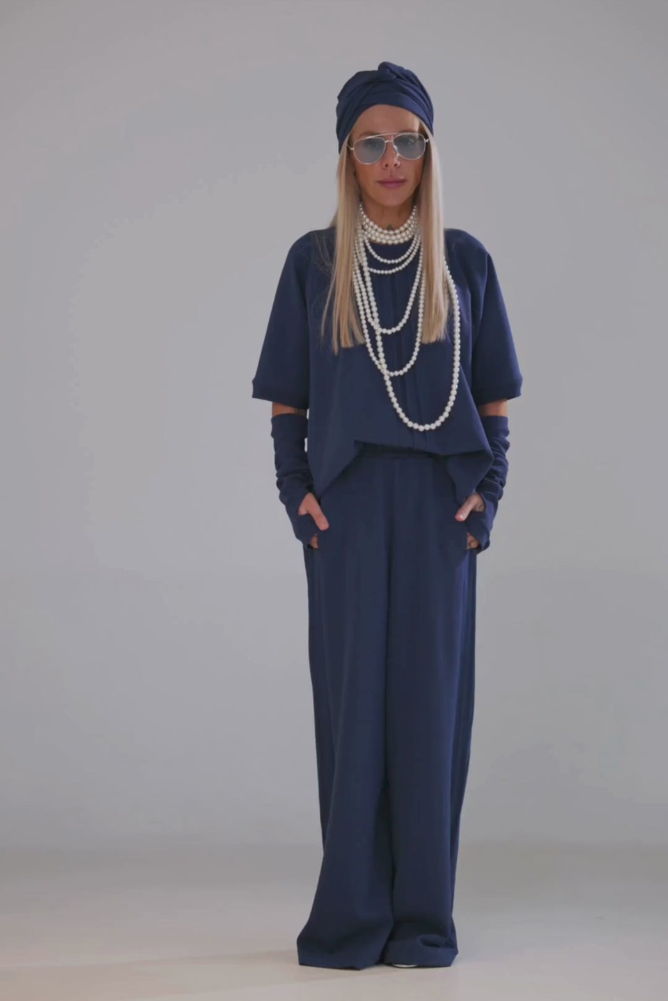 Model wearing a Navy Blue 3-Piece Set featuring a short-sleeve top, wide-leg pants, and fingerless gloves.