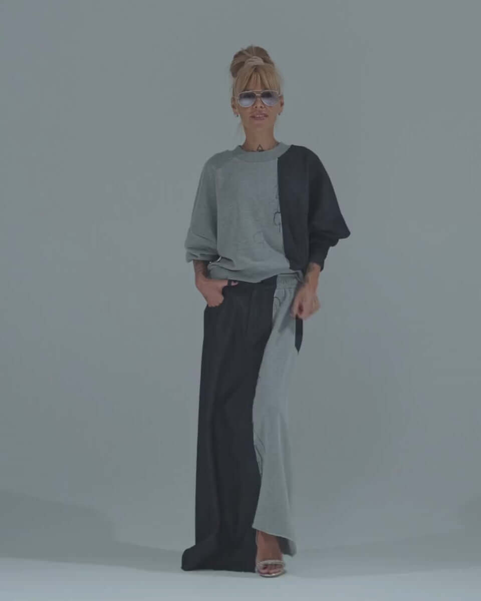 Model wearing a grey and denim co-ord set featuring an oversized sweatshirt and flowing maxi skirt.