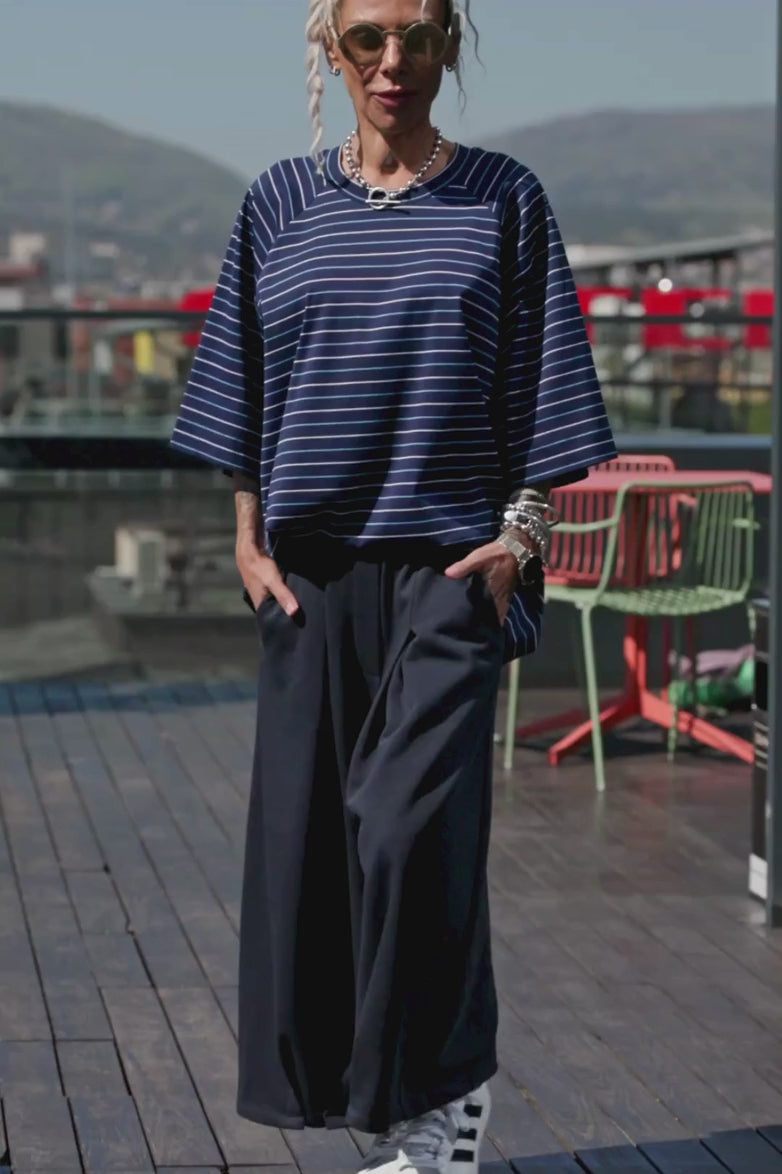 Oversized Striped Set featuring a relaxed striped T-shirt and wide-leg trousers in an urban setting.